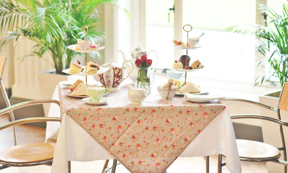 a floral table set for afternoon tea 