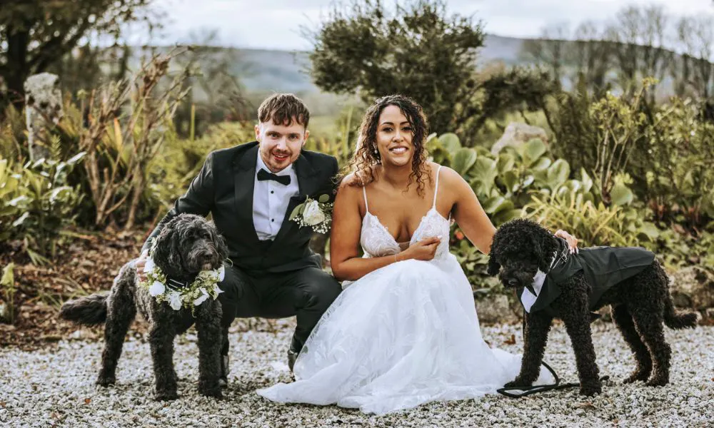 Couple getting married posing with their dog