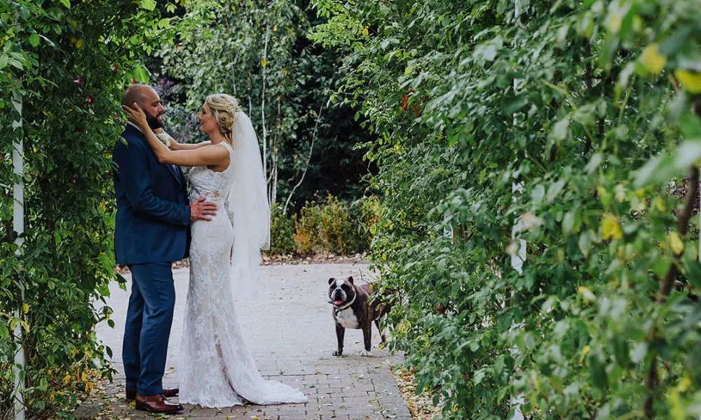 A bride and groom with their dog at the Ferry House