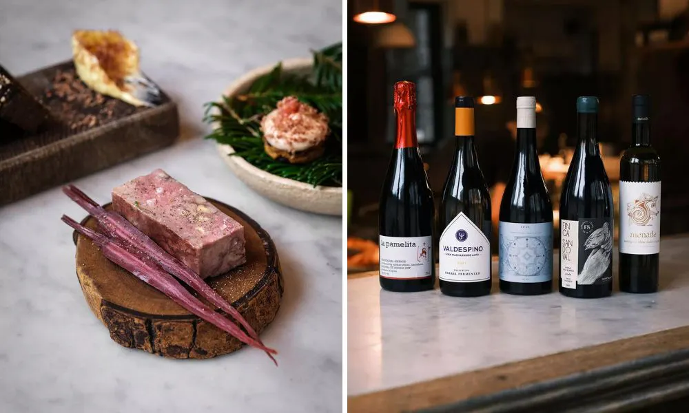 a plate of food and several bottles of red wine