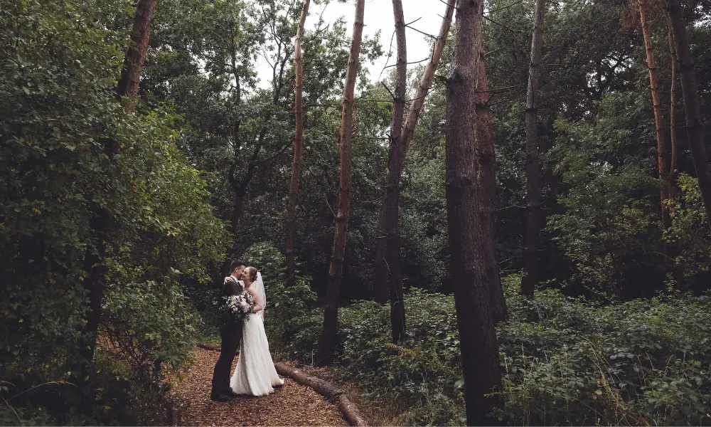 Bridge and groom hugging on a woodland trail