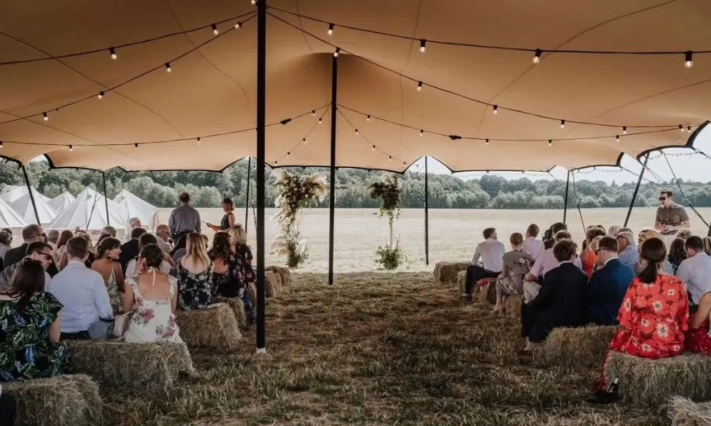 canvas tent with arbour covered in dried flowers