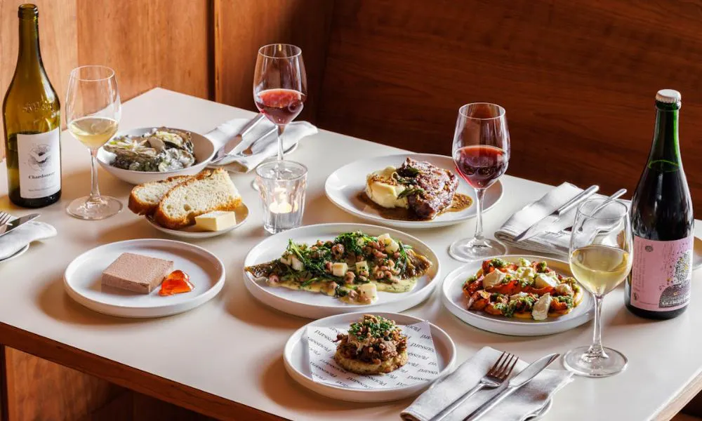 Table shot of dishes and wines