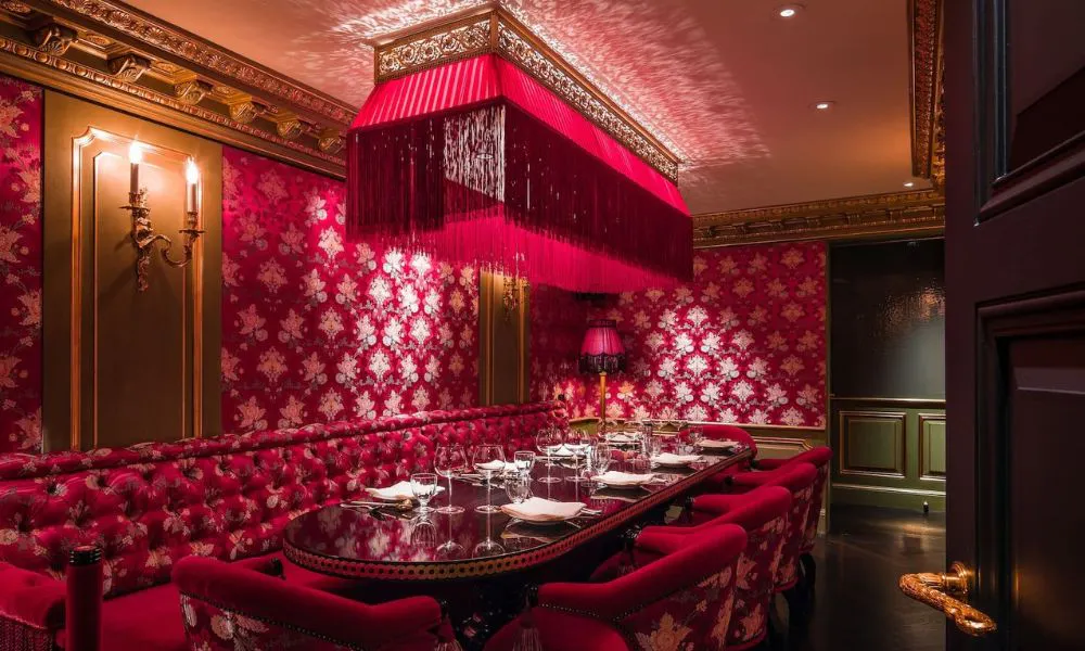 red salon with floral wallpaper and red chairs