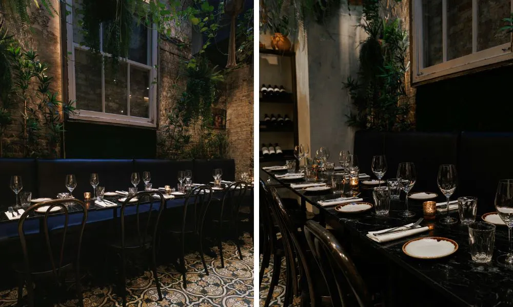 elegant outdoor private dining with plants and exposed brick walls