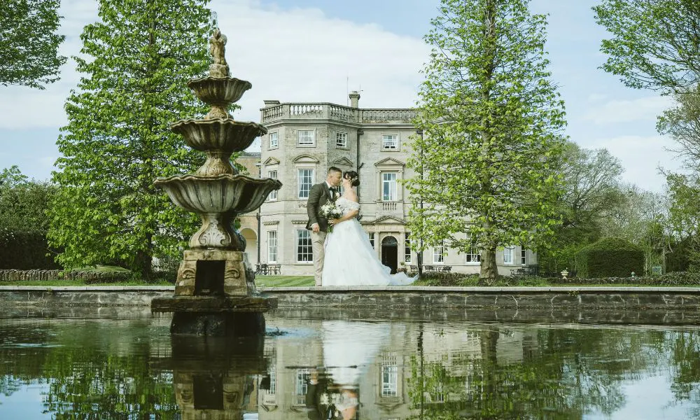 bride and groom outside of a country house