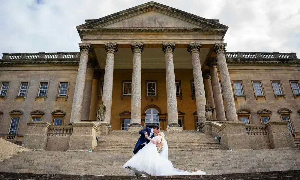 bride and groom on the steps of Prior Park in Bath