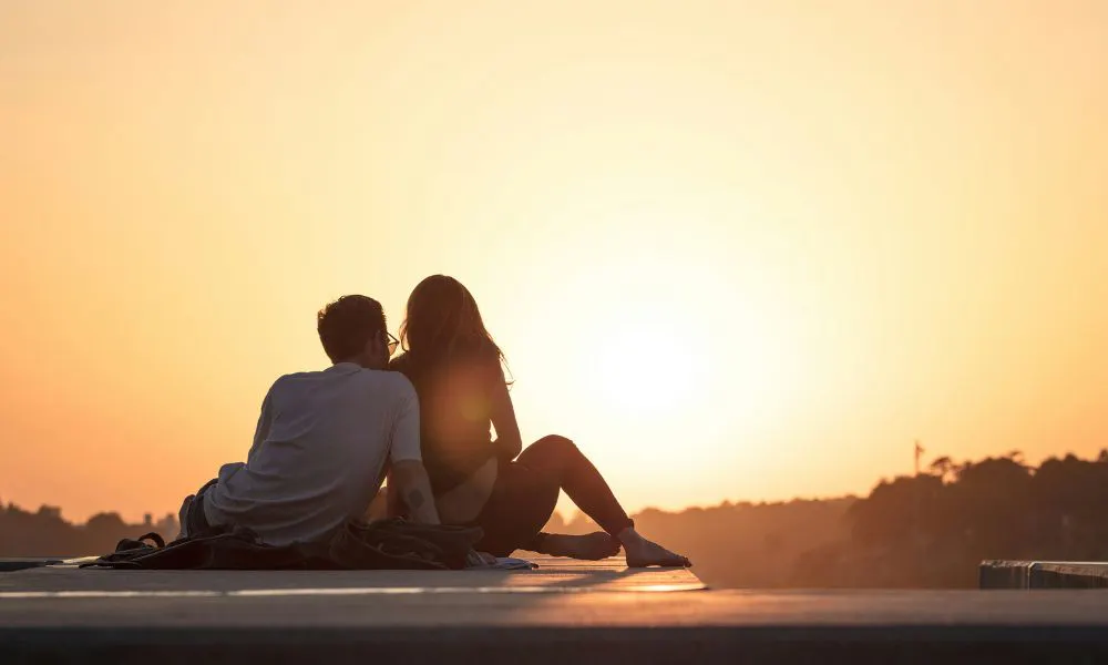 Couple hugging in sunset