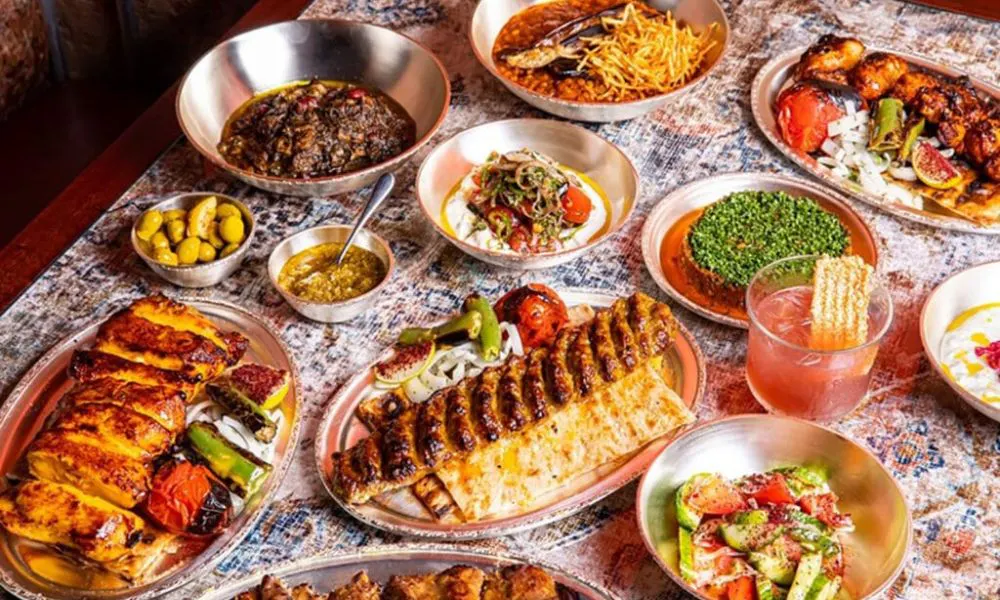 assortment of small and larger plate on a white tablecloth