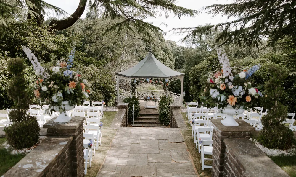 pergola flanked by floral arrangements