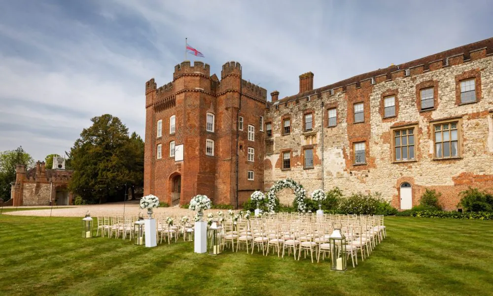 Large castle building with wedding ceremony set up