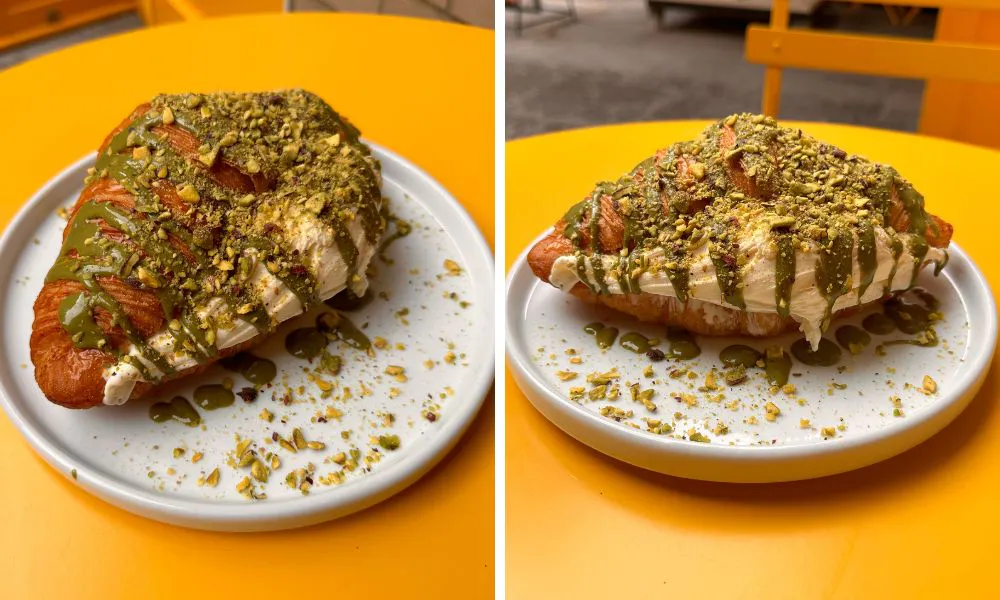 a croissant filled with ice cream and topped with pistachios