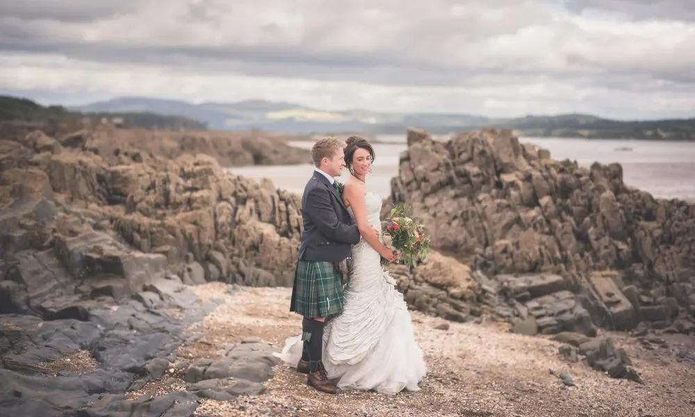 a couple in wedding dress on a clifftop