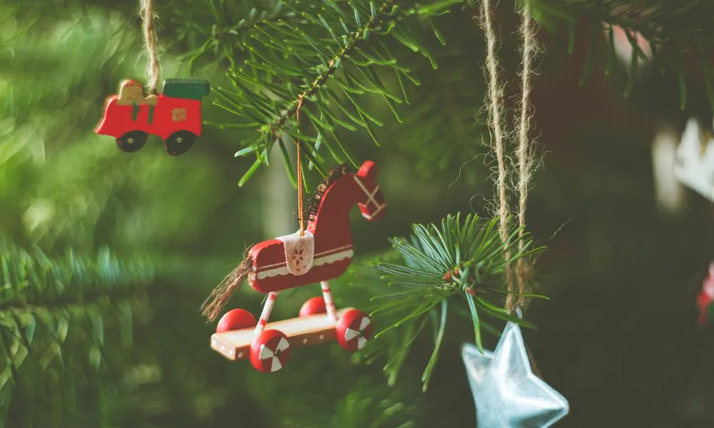 wooden horse bauble handing on pine tree