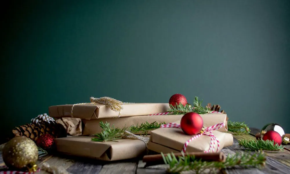 Pile of brown paper wrapped gifts tied with ribbons