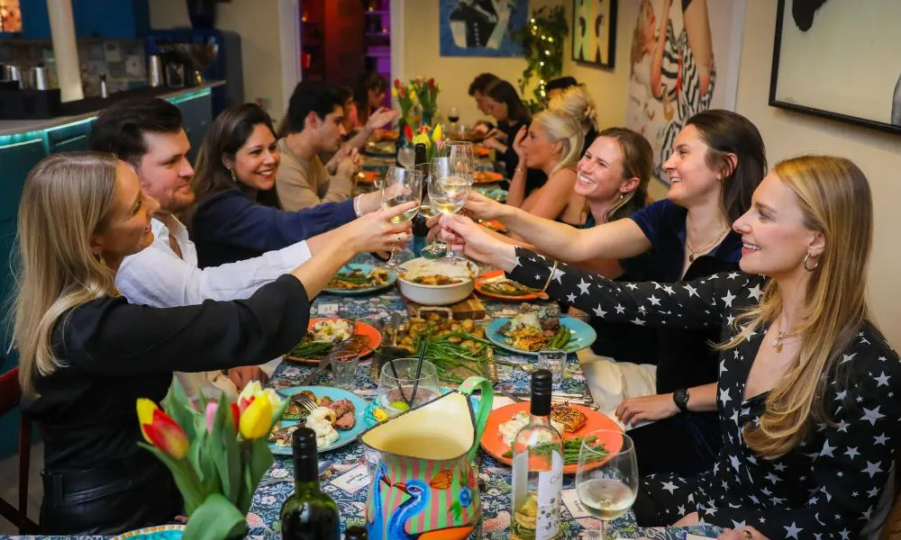 a group of people having dinner 