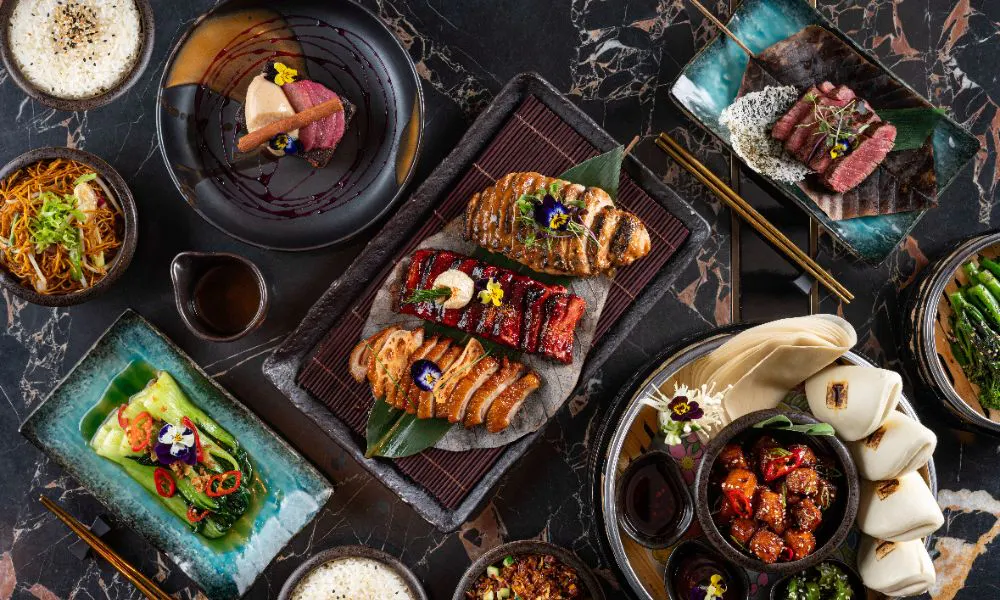 selection of asian roast dishes, with bao buns