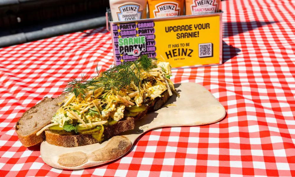 an open sandwich on a gingham table cloth