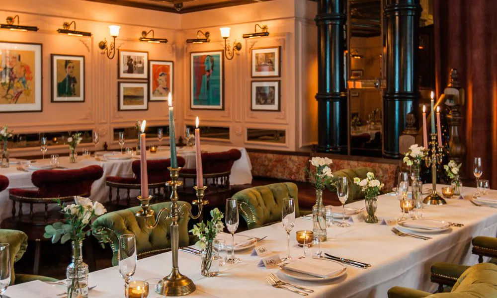 wood panelled pub room with candlelit tables