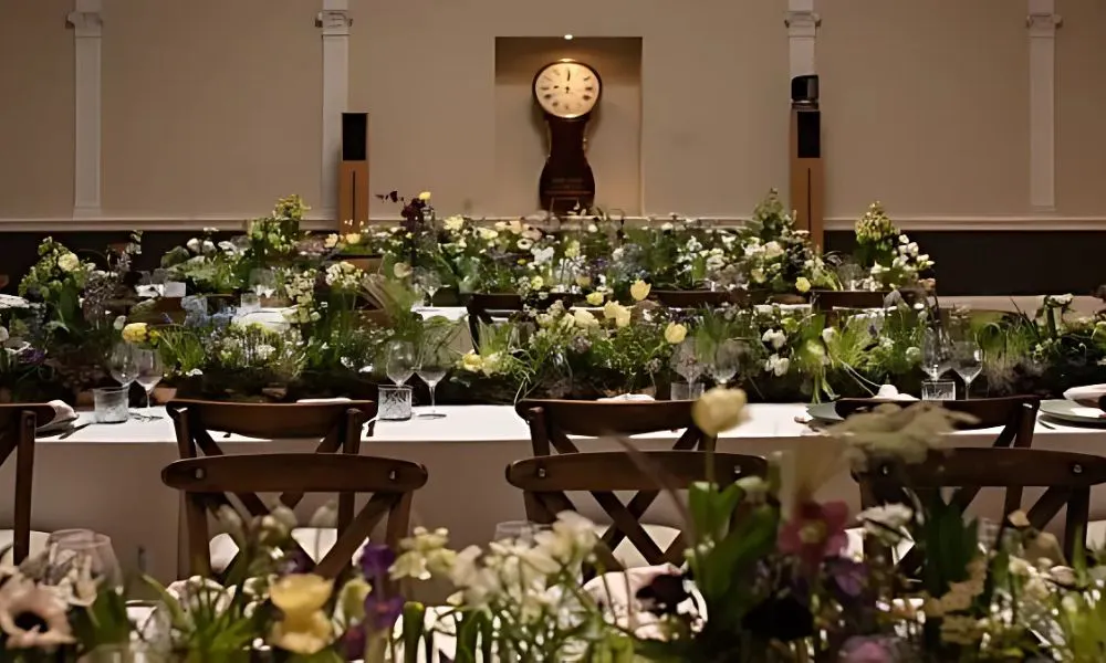 wedding tables covered in flowers and greenery