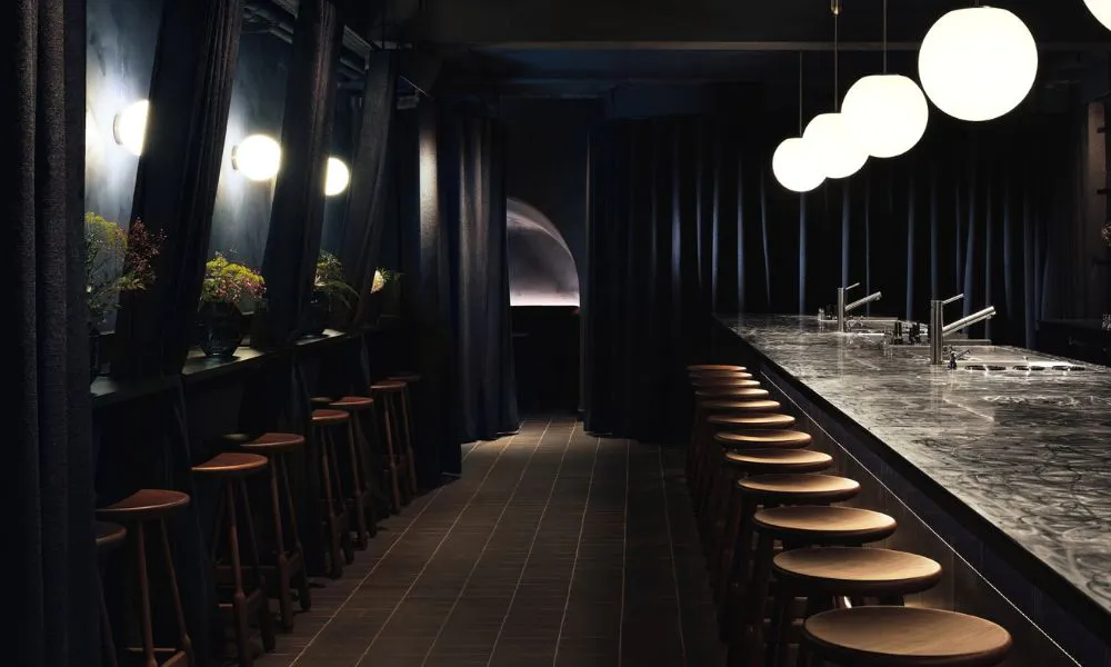 dark and moody cocktail counter lit by globe lighting