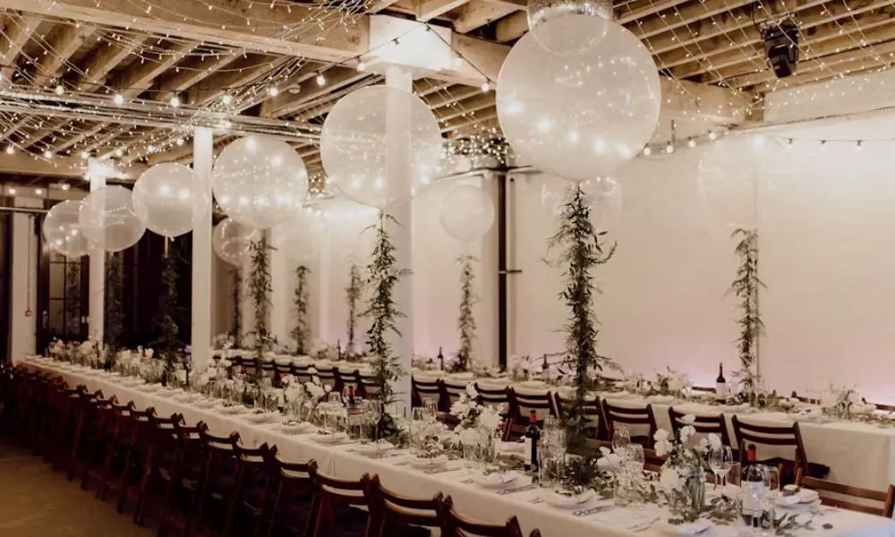 Balloons hanging above wedding table decor