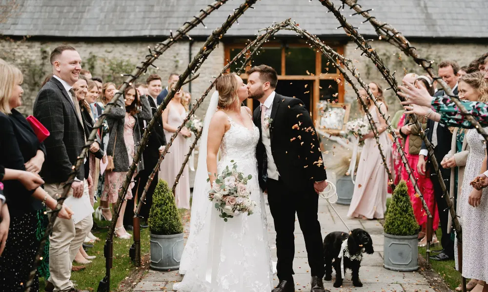 couple kissing under pointed arbour