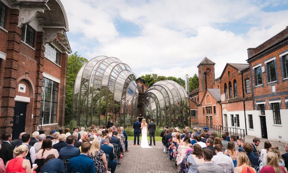 wedding ceremony with glass sculpture behind