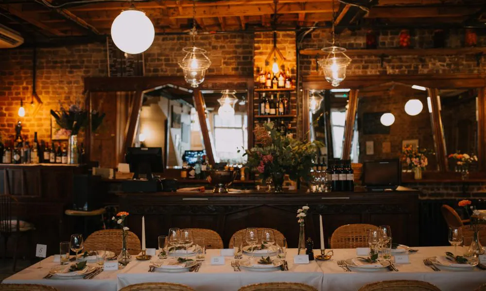 wedding table in intimate restaurant with brick walls