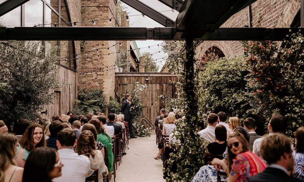 courtyard ceremony with lights and foliage decor