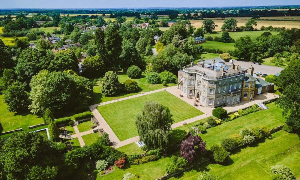 drone view of stately hall set in the countryside