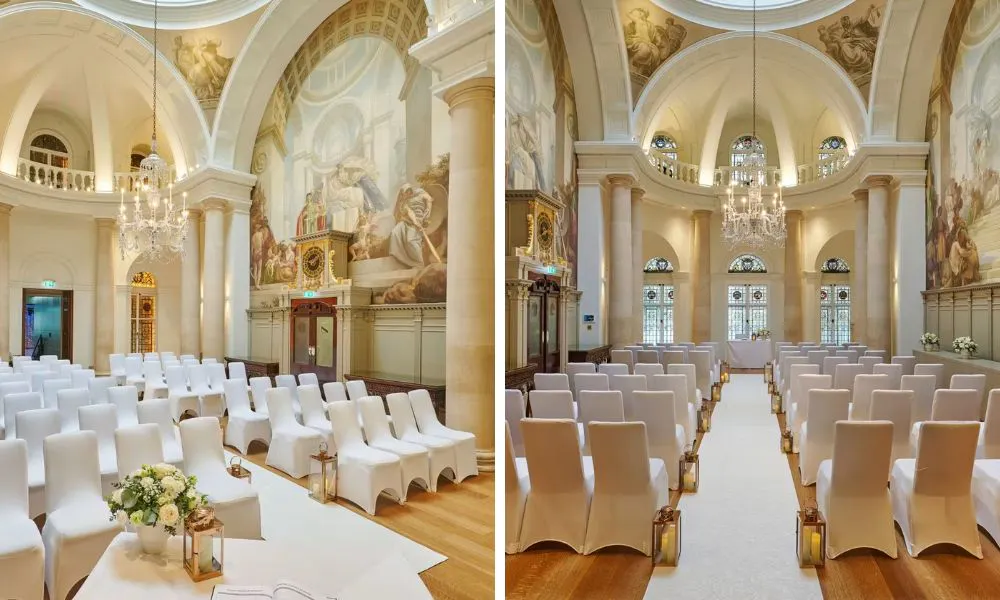 great hall with white chairs set up for wedding ceremony