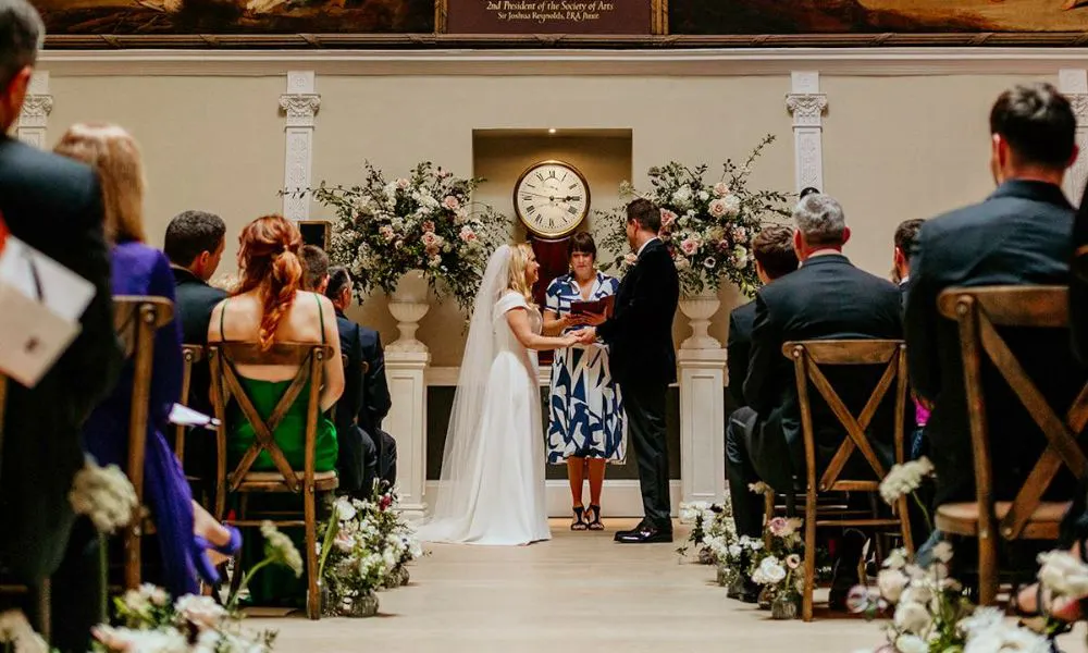 wedding ceremony with ornate flower vases