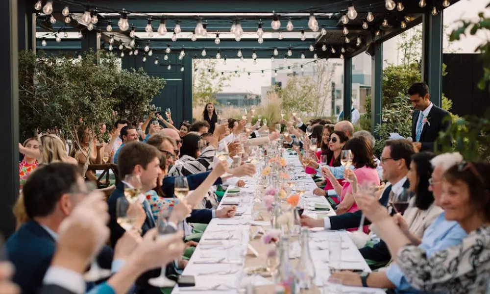 rooftop restaurant with wedding party and string lights