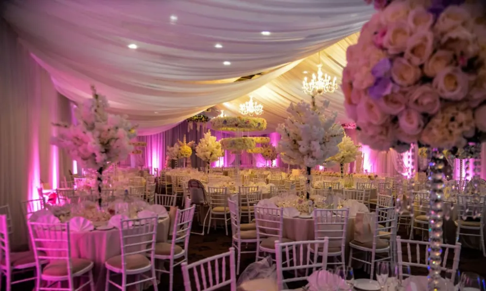 Asian wedding breakfast hall with white florals