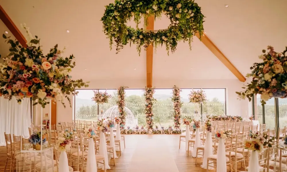 wedding ceremony space with lots of flowers and a view