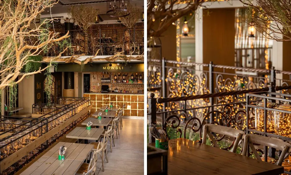 restaurant interiors with fairy lights long wooden tables and tree