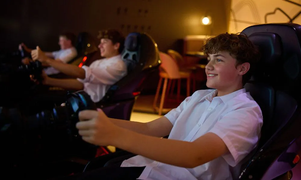 kids on a racing simulator at F1 Arcade