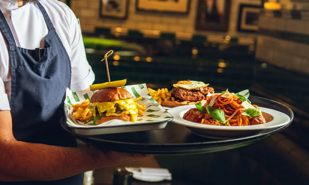 a tray of burgers and spaghetti and meatballs