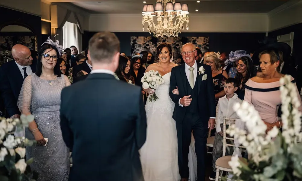 bride walking down the aisle at downham hall 