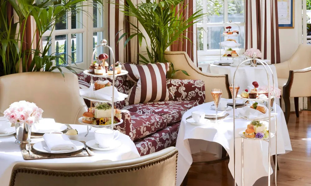 bright afternoon tea lounge with trays of cakes