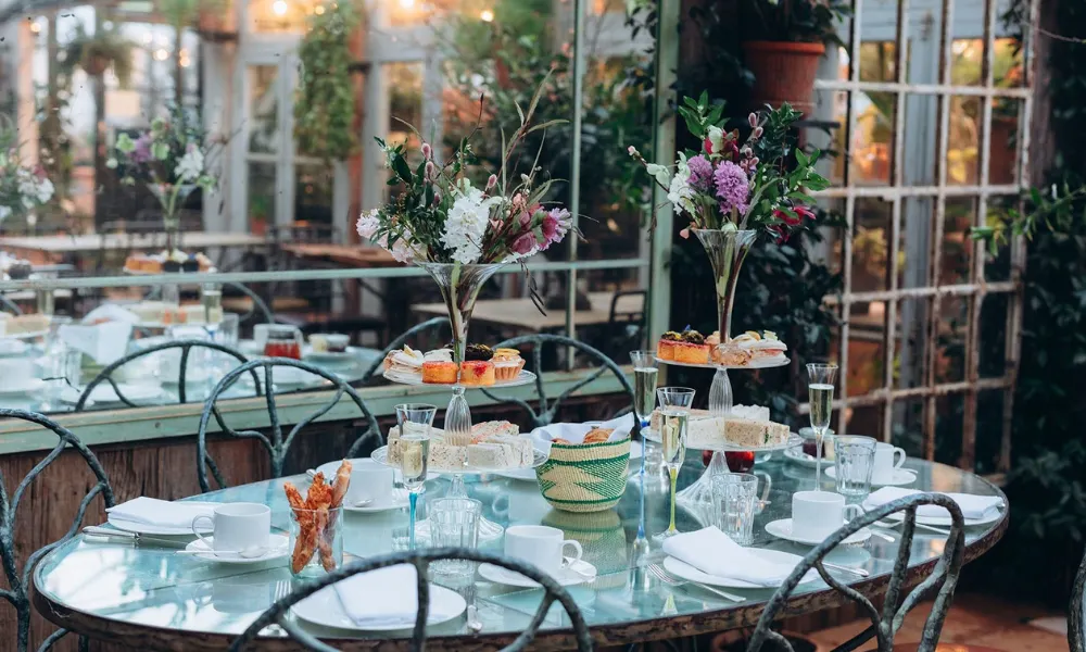 Garden courtyard with afternoon tea trays and flowers