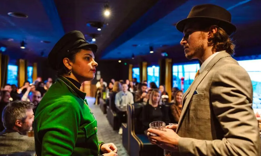 live actors performing a murder mystery on a train