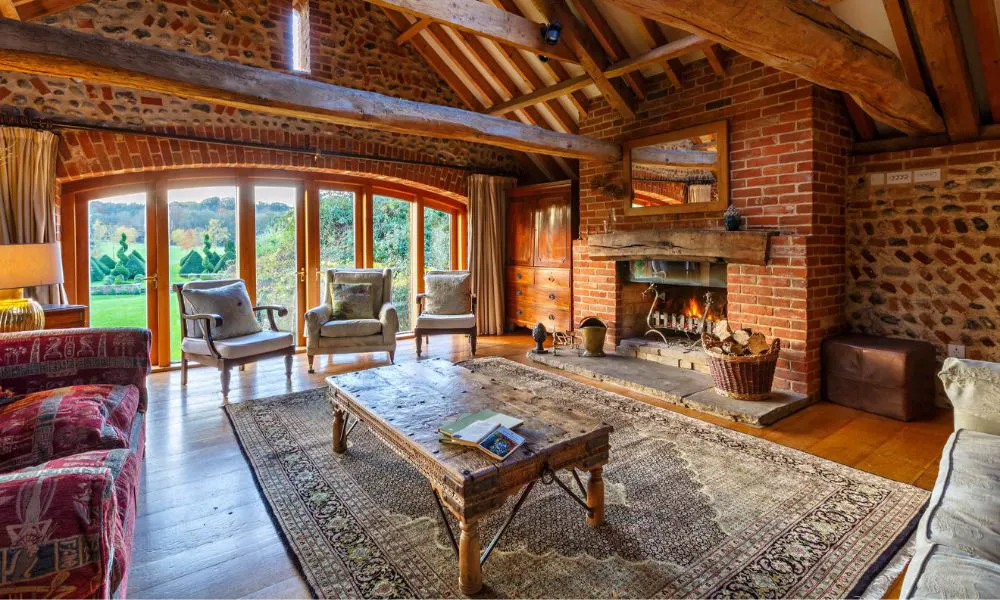 a cosy cabin with armchairs and a fireplace