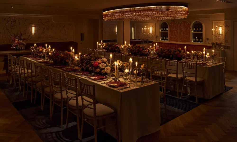 low-lit wedding dinner space with chandelier