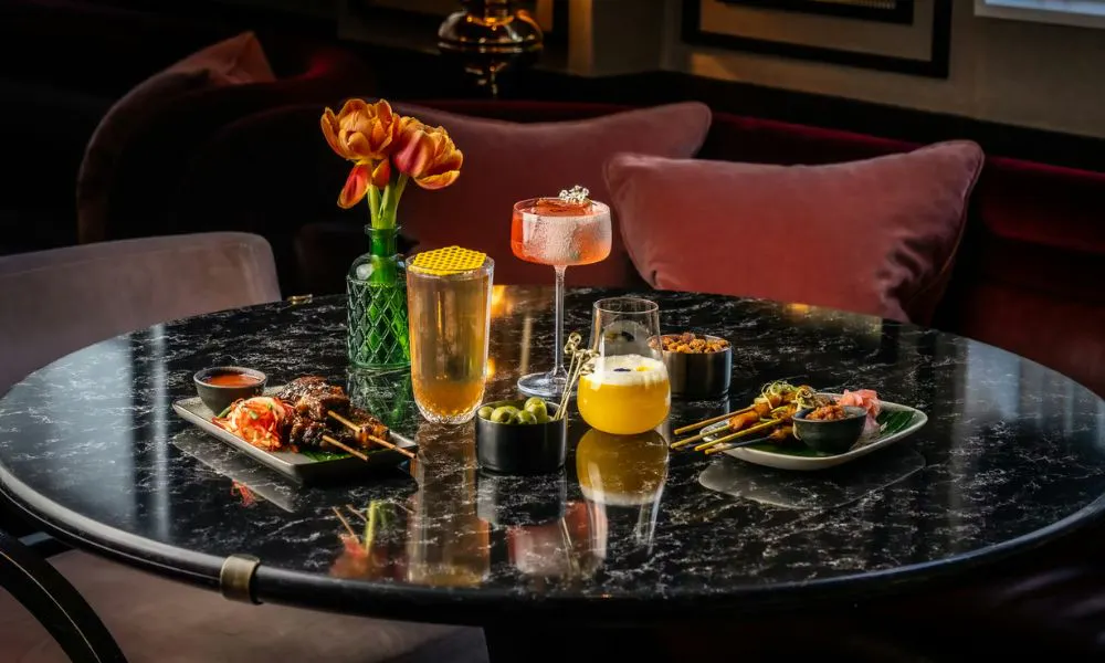a selection of drinks and snacks on a marble-topped table