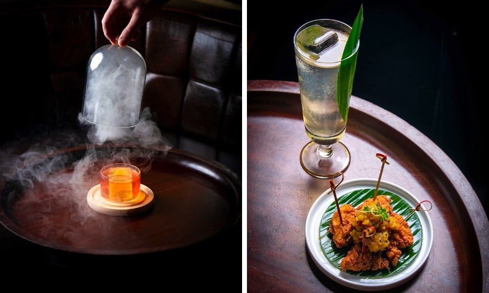 Cocktail under a glass bell jar filled with smoke