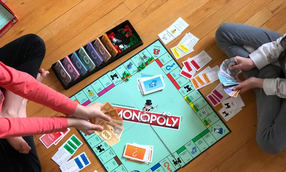 Monopoly board and pieces laid out on the floor