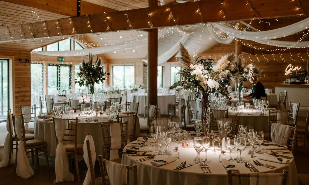 a cosy barn wedding breakfast set up