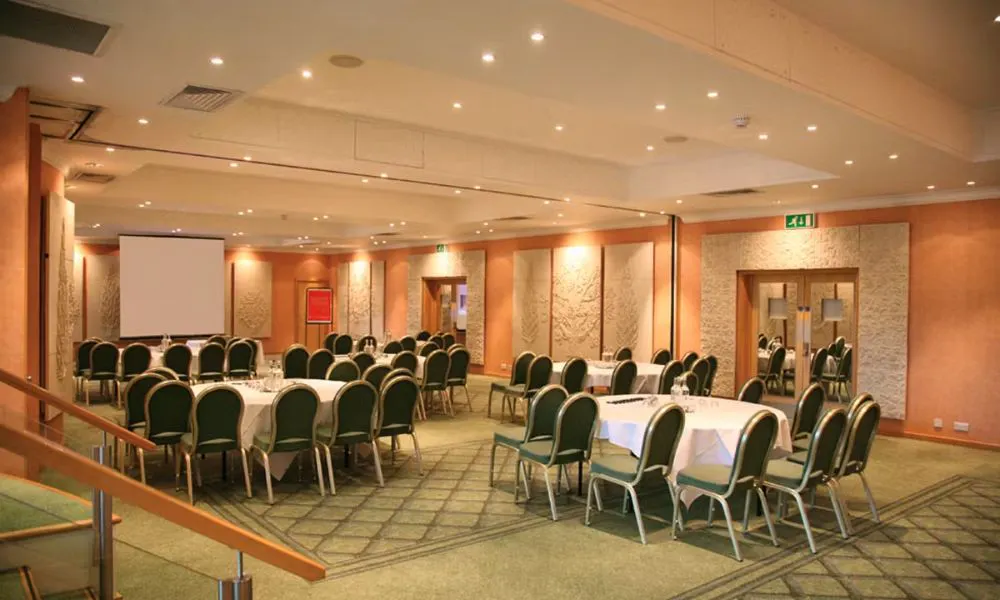 A conference set up with screen and projector